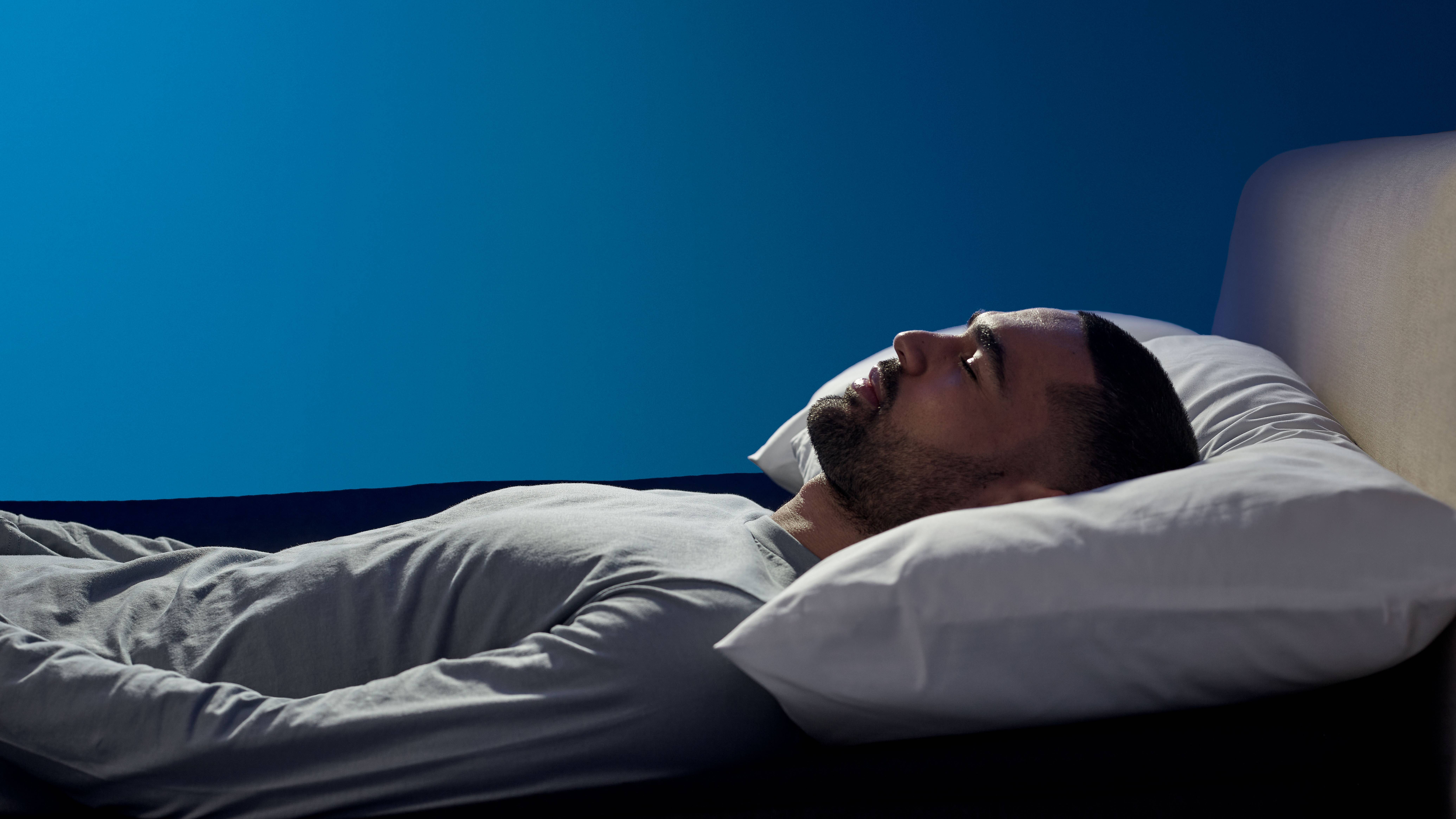 Man sleeping on the Eight Sleep Pod 4 cover