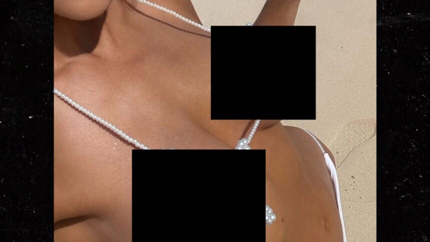 Revealed: The Sultry Star Turning Heads with Her Dazzling Pearl Bikini Selfie!